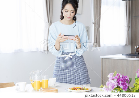 A woman shooting a dish A woman shooting a dish 44800512
