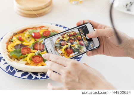A woman shooting a dish 44800624