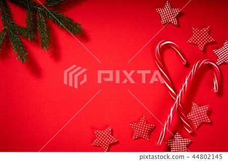 christmas sweets ,stars and spruce on a red background christmas sweets ,stars and spruce on a red background 44802145