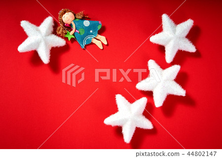 christmas white stars and fabric angel on a red background christmas white stars and fabric angel on a red background 44802147