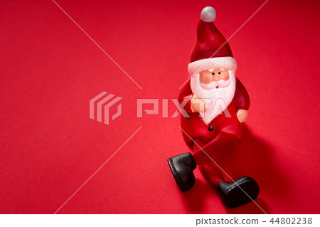 santa claus figurine on a red background santa claus figurine on a red background 44802238