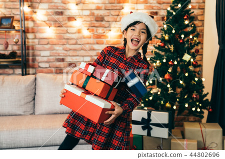 girl holding gift at Christmas holiday at home. girl holding gift at Christmas holiday at home. 44802696