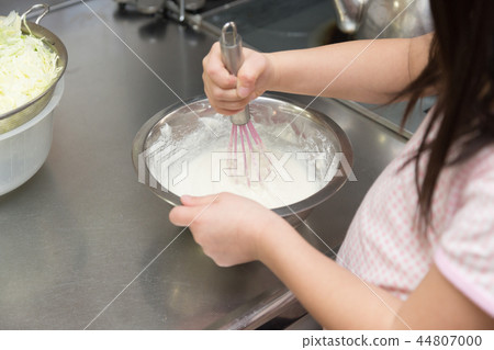 Girl mixing flour 44807000