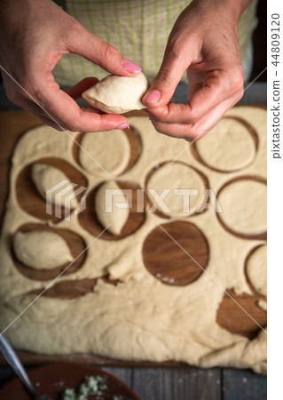 A woman making pies 44809120