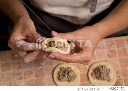 A woman is making pies 44809451