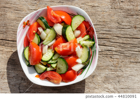 Fresh vegetable salad  with tomatoes, cucumbers 44810091