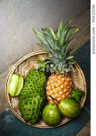 Tropical fruit on a concrete floor 44810286