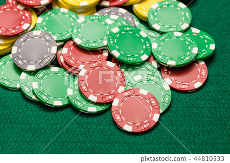 Casino chips on green table Casino chips on green table 44810533