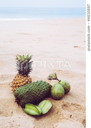 Exotic fruits on the sand, toned 44810897