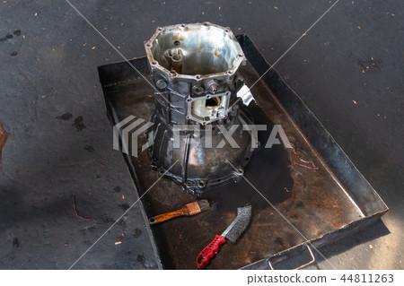 Old engine repairers in the garage. Old engine repairers in the garage. 44811263