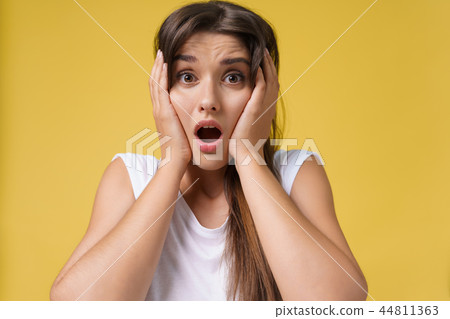 Close up Portrait young beautiful attractive student girl shocking with something. Bright Yellow 44811363