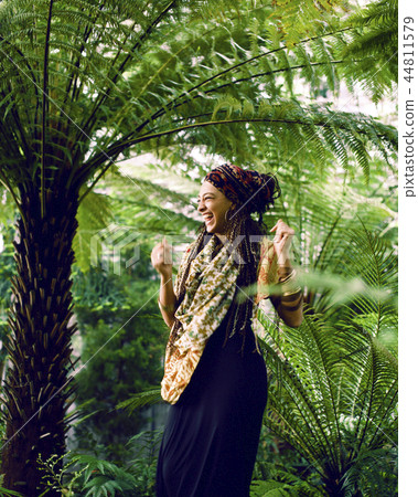 young adorable pretty girl with pigtails hairstyle smiling outside among trees young adorable pretty girl with pigtails hairstyle smiling outside among trees 44811579