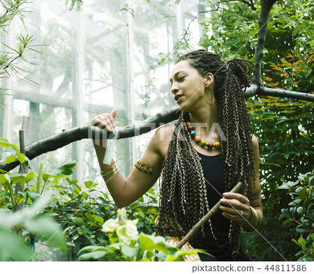 young adorable pretty girl with pigtails hairstyle smiling outside among trees 44811586