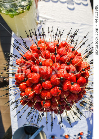 Fresh delicious strawberries gathered into a ball on the buffet table Fresh delicious strawberries gathered into a ball on the buffet table 44813986