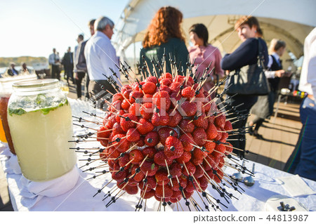 Fresh delicious strawberries gathered into a ball on the buffet table Fresh delicious strawberries gathered into a ball on the buffet table 44813987