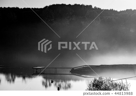 the pier on the lake. sunset, fog on the lake the pier on the lake. sunset, fog on the lake 44813988
