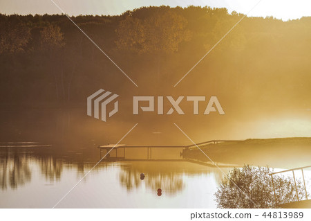 the pier on the lake. sunset, fog on the lake the pier on the lake. sunset, fog on the lake 44813989