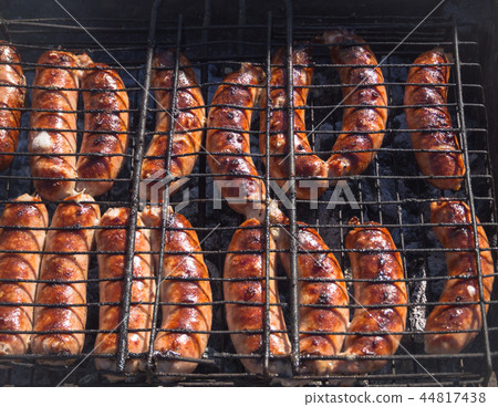 Meat sausages are fried on smoke. Top view.  44817438