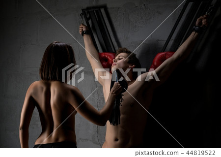 Beautiful couple performing bdsm play cropped view 44819522