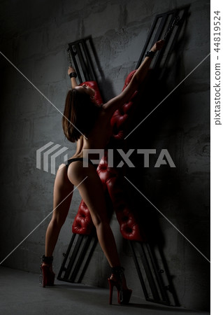 Brunette topless rearview tied to bdsm cross 44819524