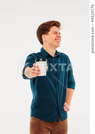 happy young man holding coffee to go happy young man holding coffee to go 44820176