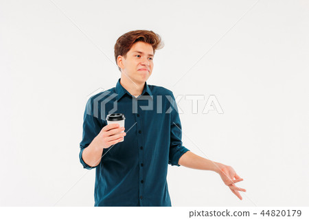 Uncertain doubting man student with Cup of coffee Uncertain doubting man student with Cup of coffee 44820179