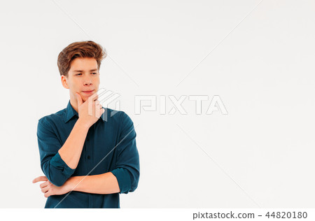 Pensive teenager student on white background Pensive teenager student on white background 44820180