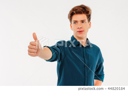Attractive smiling boy student showing thumbs up  44820184