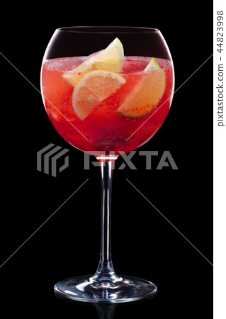 Cold sangria in a wine glass isolated on black Cold sangria in a wine glass isolated on black 44823998