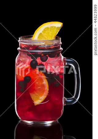 Cocktail with currant and vodka in mason jar mug Cocktail with currant and vodka in mason jar mug 44823999