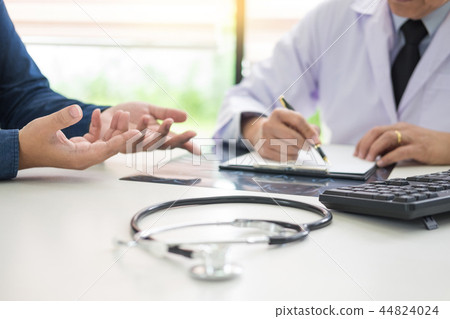 doctor giving a consultation discussing to patient and explainin 44824024