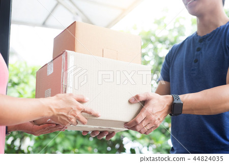 woman courier holding a parcel Shipping Mail appending signature 44824035