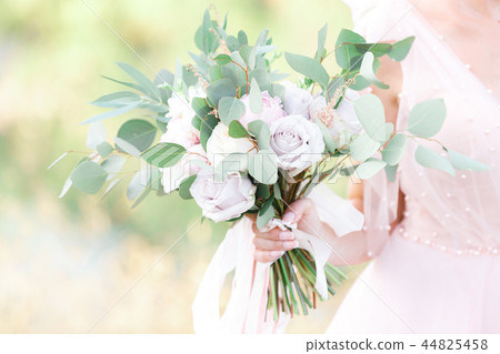 bride's hands hold beautiful bridal bouquet outdoor bride's hands hold beautiful bridal bouquet outdoor 44825458