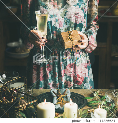 Woman holding glass of champaigne and gift box, square crop 44826624