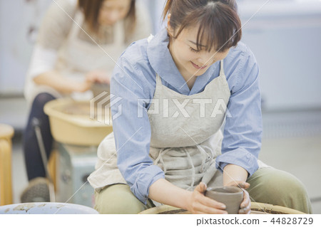 A woman doing ceramics 44828729