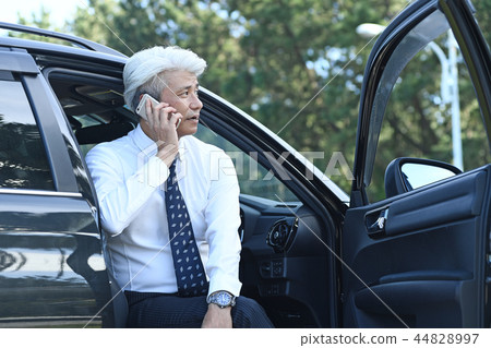 Businessman romance gray on the phone at parking lot Businessman romance gray on the phone at parking lot 44828997