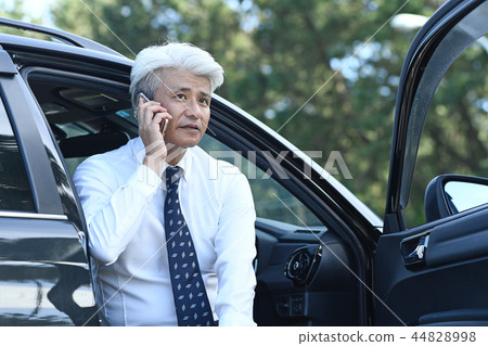 Businessman romance gray on the phone at parking lot Businessman romance gray on the phone at parking lot 44828998