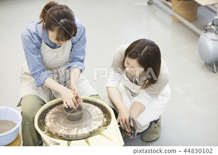 A woman doing ceramics 44830102