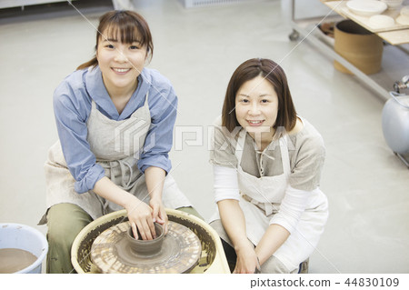 A woman doing ceramics 44830109