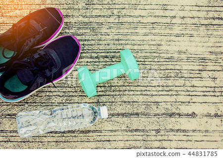 Sports shoes with bottle and green color dumbbell Sports shoes with bottle and green color dumbbell 44831785