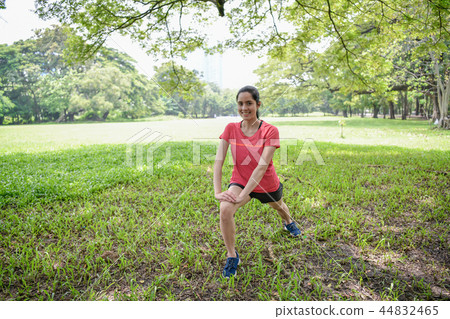 Exercise concept. Beautiful girl is stretching her muscles. Beau Exercise concept. Beautiful girl is stretching her muscles. Beau 44832465