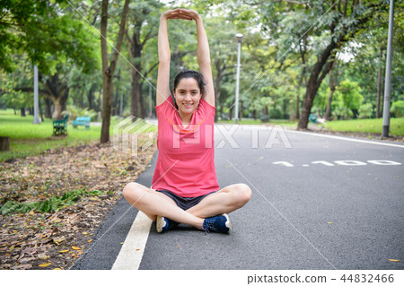 Exercise concept. Beautiful girl is stretching her muscles. Beau Exercise concept. Beautiful girl is stretching her muscles. Beau 44832466