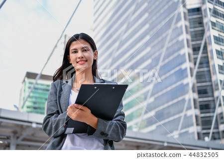 Business concept. Beautiful young businesswoman is working outdo Business concept. Beautiful young businesswoman is working outdo 44832505