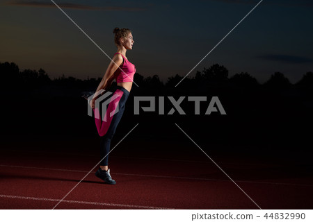 Sporty woman doing stretching for legs after running. 44832990