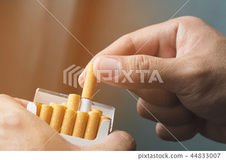 Man is picking Cigarette from Package  44833007