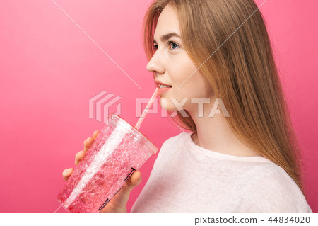 Portrait of beautiful young woman drinking fizzy Portrait of beautiful young woman drinking fizzy 44834020