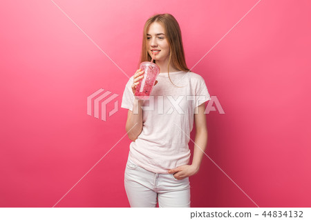 Portrait of beautiful young woman drinking Portrait of beautiful young woman drinking 44834132