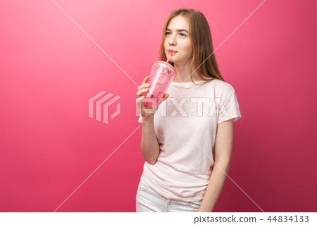 Portrait of beautiful young woman drinking Portrait of beautiful young woman drinking 44834133