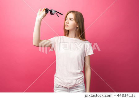 Beautiful young blonde girl in glasses standing Beautiful young blonde girl in glasses standing 44834135