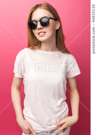 Beautiful young blonde girl in glasses standing Beautiful young blonde girl in glasses standing 44834138